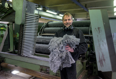 Man holding wool in the fabric 
